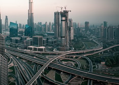 A skyline of a large modern city with a network of highways