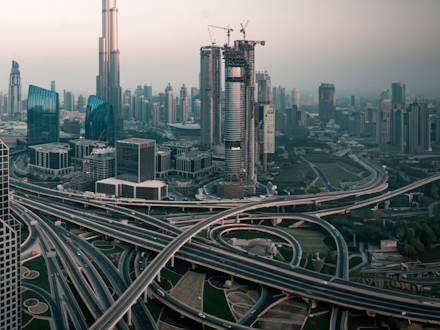 A skyline of a large modern city with a network of highways